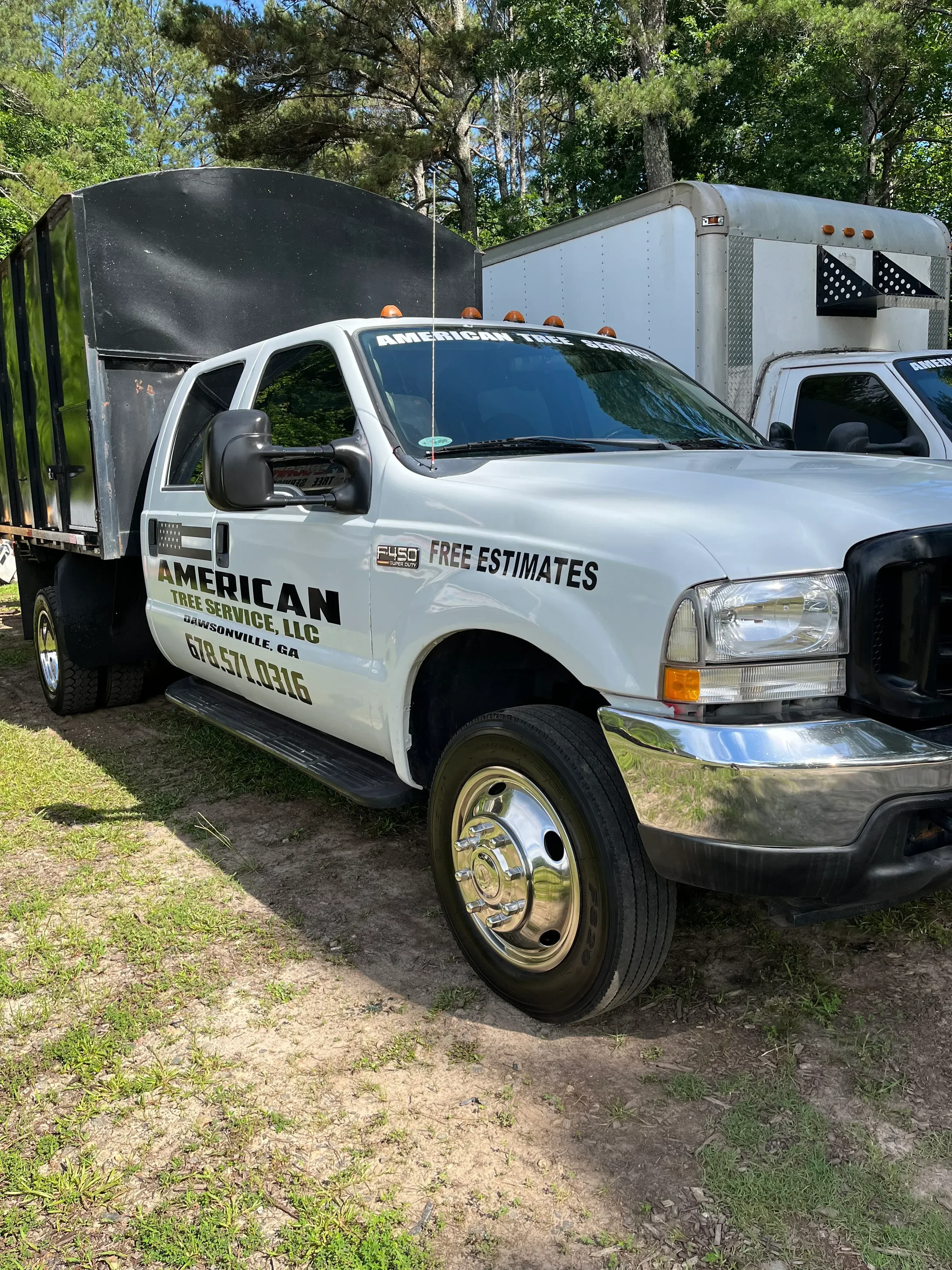 White service truck with blue vinyl wrap, company logo, and perforated window graphics